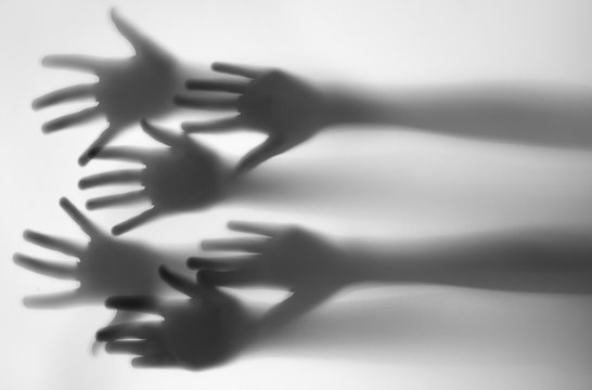 Shadow Of A Hands Behind Transparent Paper