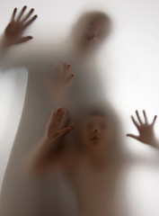 shadow of people behind transparent paper