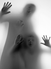 shadow of peoplel behind transparent paper