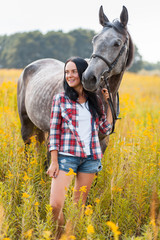 Young woman with a horse