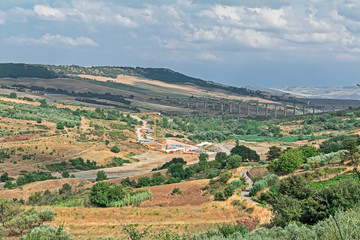 green landscape of valley with a bridge and crane 