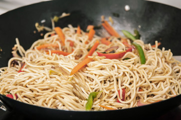 Preparing chinese noodles in a wok