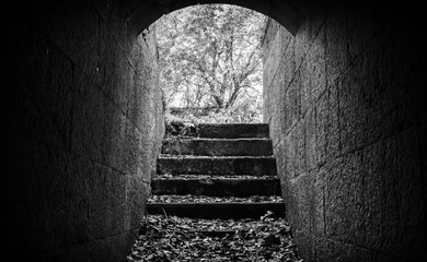 Stairs from dark abandoned concrete tunnel interior