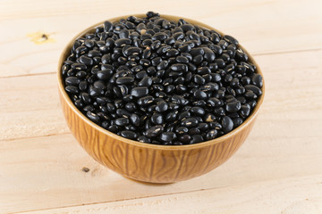 black beans on wood background