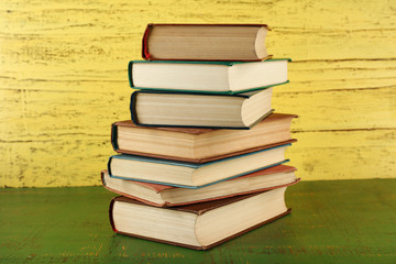 Stack of books on wooden background