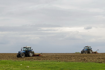 Two wheeled tractors sow a field of wheat, Ludogorie, Bulgaria 