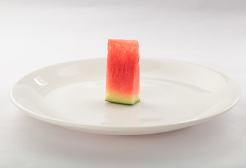 Slice of watermelon in White plate on white background