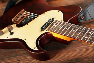 Fototapeta na wymiar Electric guitar on wooden table close up