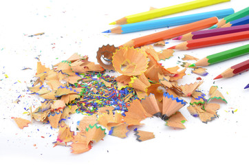 Shavings from multicolored pencils on white background