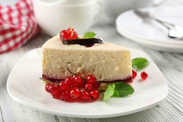 Delicious cheesecake with berries on table close up