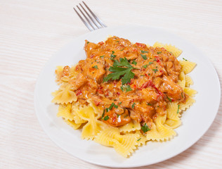 meat in a sauce with farfalle pasta