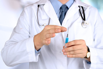 Young Doctor with syringe in his hand
