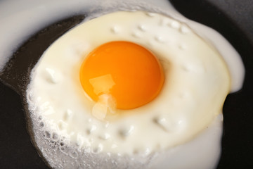 Scrambled egg on black pan background