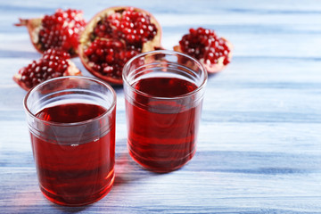 Fresh garnet juice with fruit on table close up