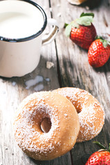 Donuts with milk and fresh strawberries