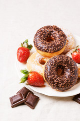 Chocolate donuts with fresh strawberries