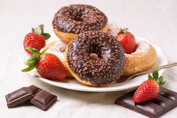 Chocolate donuts with fresh strawberries