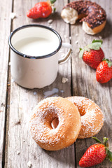 Donuts with milk and fresh strawberries