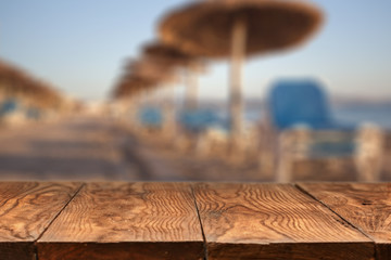 wooden table and Empty beach on background