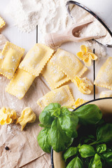 Pasta ravioli on flour with basil