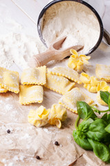 Pasta ravioli on flour with basil