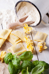 Pasta ravioli on flour with basil