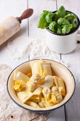 Pasta ravioli with flour and basil