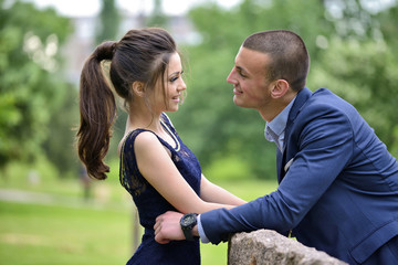 Young formally dressed couple looking lovingly at each other
