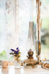 Iterior window with vintage lamp and wildflowers