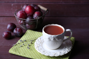 Delicious plum juice with fruits on wooden table close up
