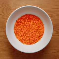 White Bowl with Red Lentil on Wooden Desk