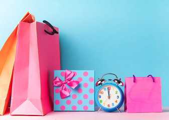 Alalrm clock and gift box with shoppings bags