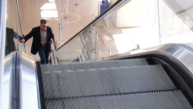 Business Man on Cell Phone on Escalator 4172
