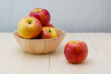 Red apple in wooden plate