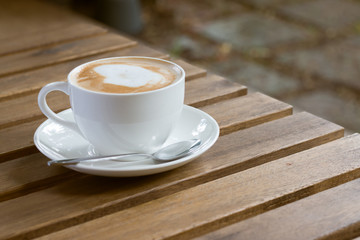 Coffee cup in garden coffee shop - vintage style effect picture