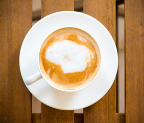 Coffee cup top view on wooden table - vintage style effect picture
