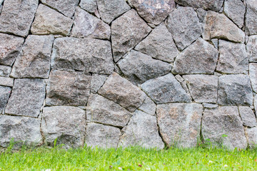 background of a stone wall  in a lawn