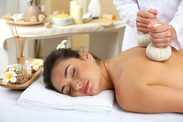 Obraz na płótnie Canvas Young woman on massage table in beauty spa salon