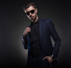 Handsome stylish young man. Brutal man with a beard and sunglasses