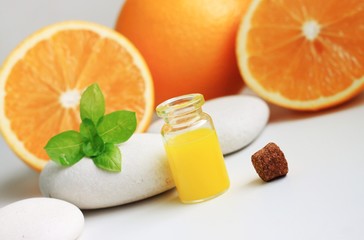 Obraz na płótnie Canvas Orange juice aromatic essential oil bottle domestic treatment