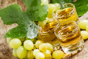 Light grape juice on wooden  background, selective focus