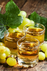 Light grape juice on wooden  background, selective focus