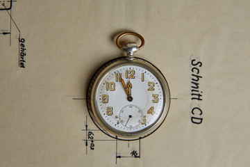 Old pocket watch on old paper