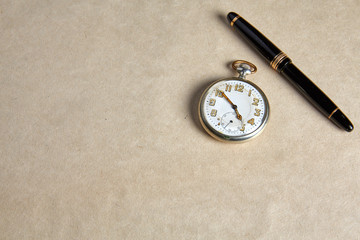 Old pocket watch on old paper