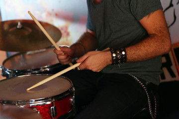 Hand of drummer  with sticks and drums, close-up