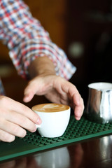 Bartender making white coffee at bar