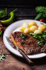 Grilled steak with potatoes