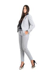 Young business woman with hands in pocket in elegant business stripped suit. 