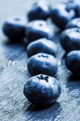 Obraz na płótnie Canvas Fresh ripe blueberries on a dark background, selective focus