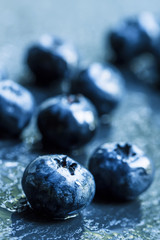 Fresh ripe blueberries on a dark background, selective focus